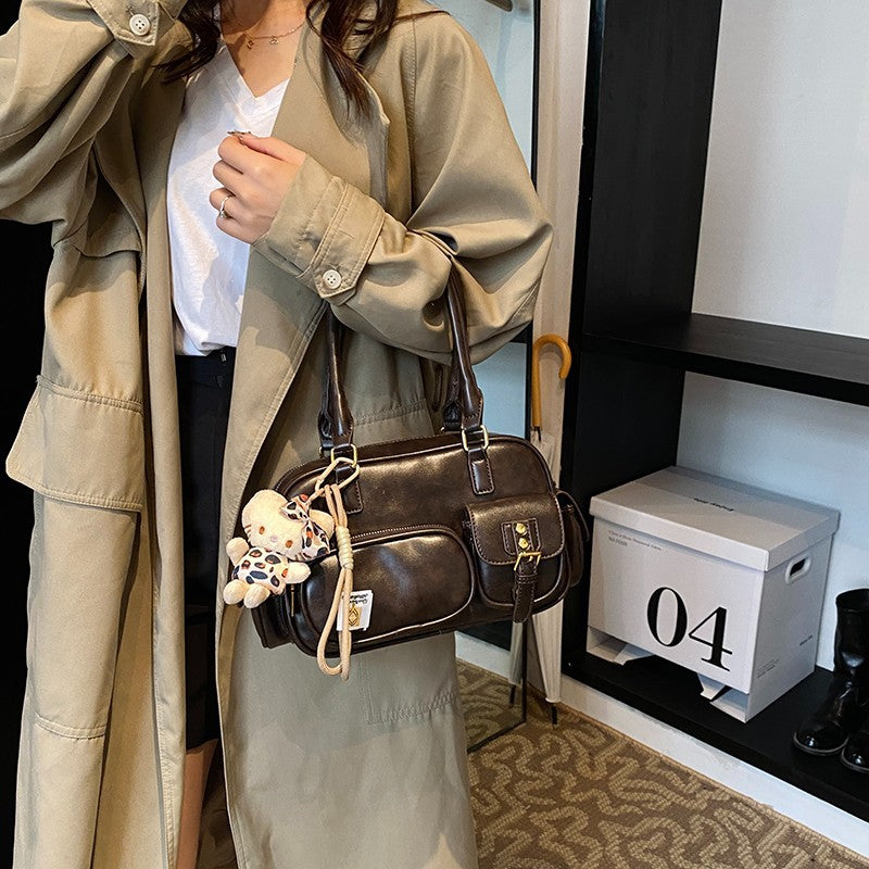 Elegant Handbag with Playful Charms and Multiple Compartments