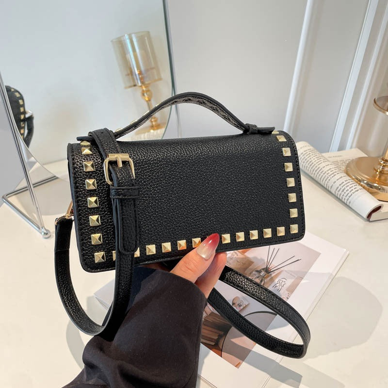 mini handbag with glittering upper material and golden studs