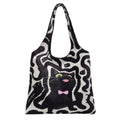 Shoulder bag with playful cat motif