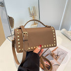 mini handbag with glittering upper material and golden studs