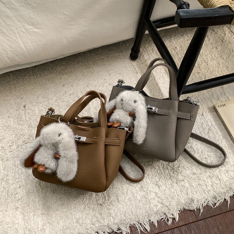 Ladies mini handbag with playful design and animal pendant