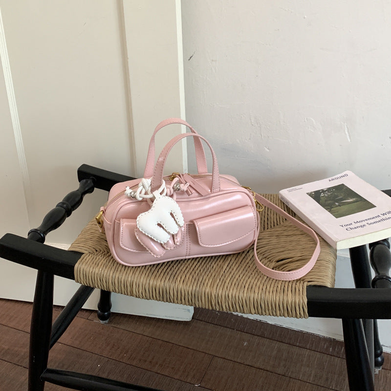 playful mini handbag with charming animal charm
