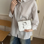 mini handbag with decorative quilting and playful cat motif