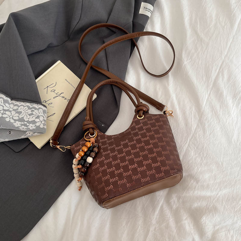 Ladies mini handbag with shimmering upper material and elegant accessories