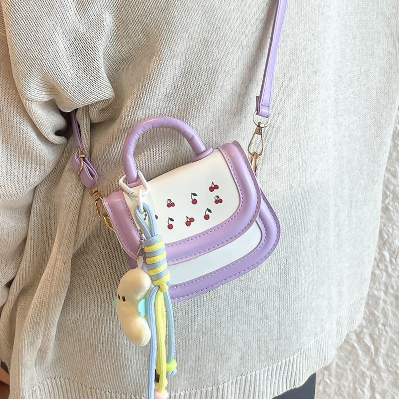 mini handbag with cheerful cherry design and charming charms
