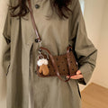 Women trendy mini handbag with playful animal pendant