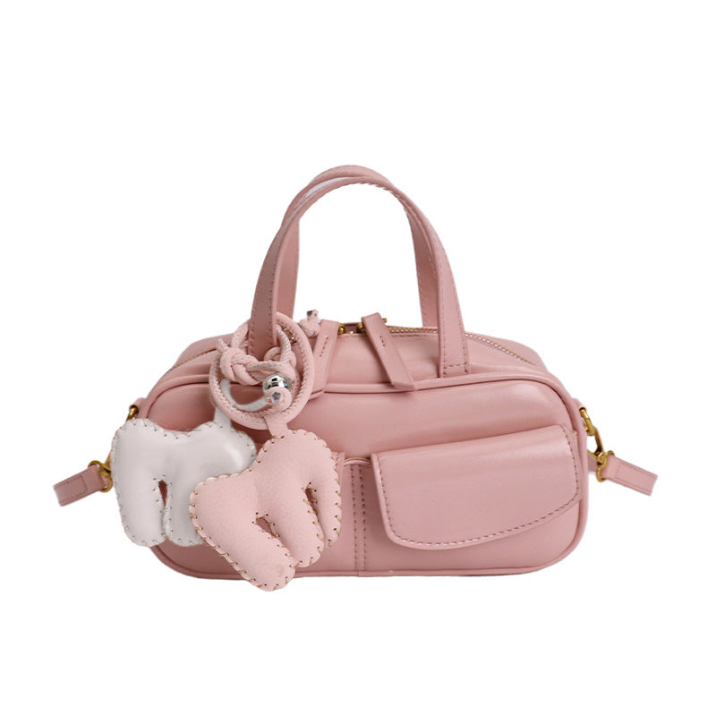 playful mini handbag with charming animal charm