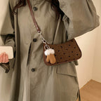 Women trendy mini handbag with playful animal pendant