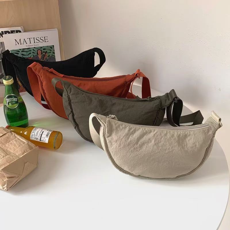 Shoulder bag with practical compartment system and adjustable shoulder strap