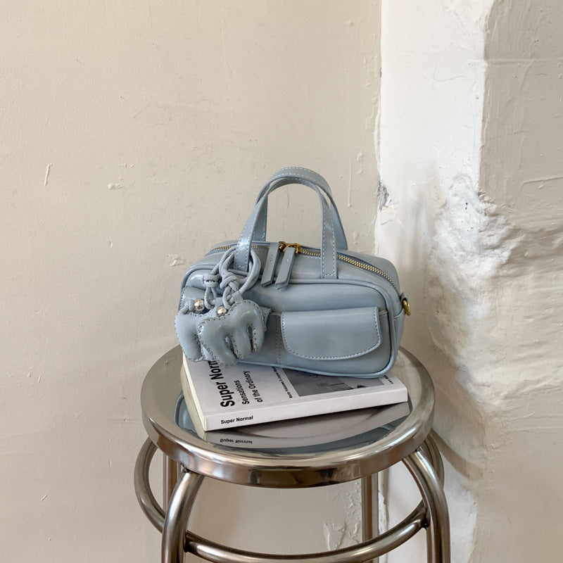 playful mini handbag with charming animal charm