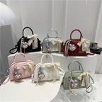 mini handbag with playful animal design and charming pendant