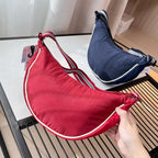 Shoulder bag with adjustable shoulder strap and versatile interior compartment