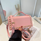 mini handbag with glittering upper material and golden studs