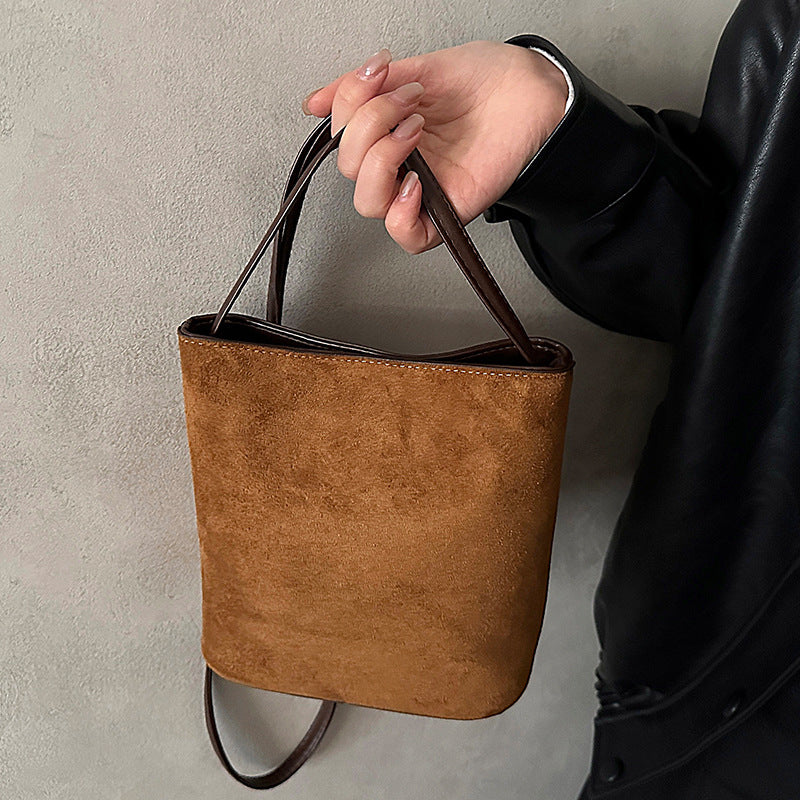 Ladies mini handbag made of soft suede with stylish carrying handle