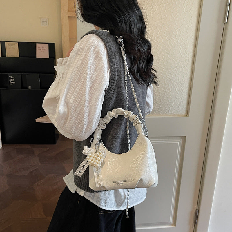 mini handbag with voluminous ruffle design and trendy pendants