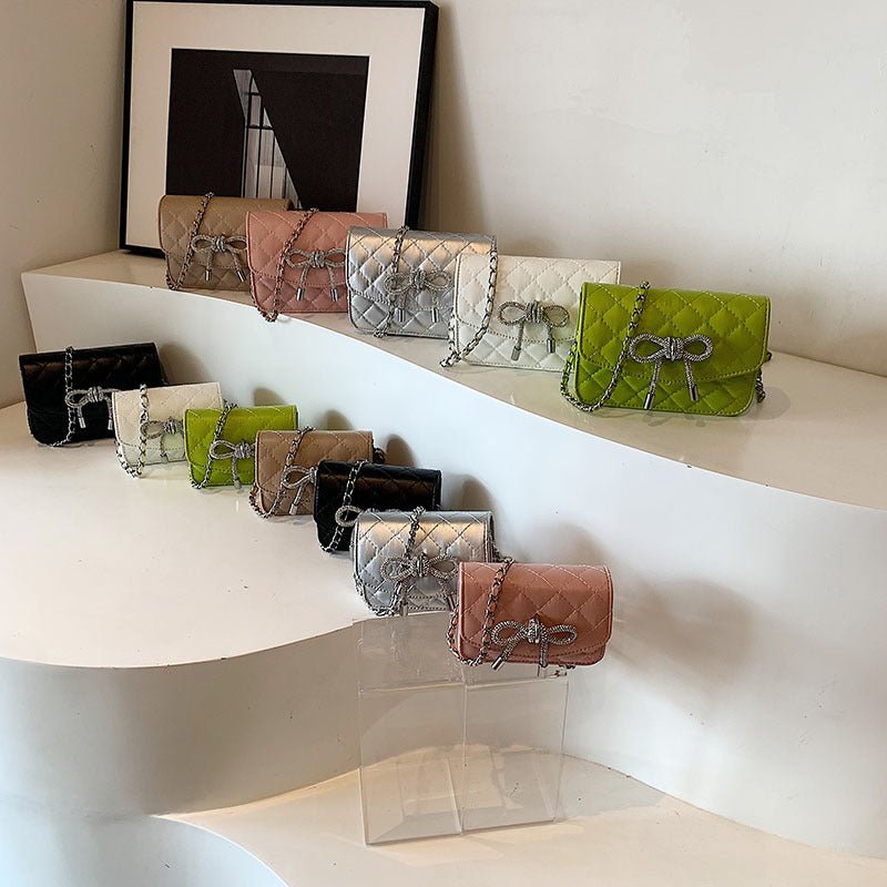 mini handbag with luxurious quilted pattern and sparkling chain pendant