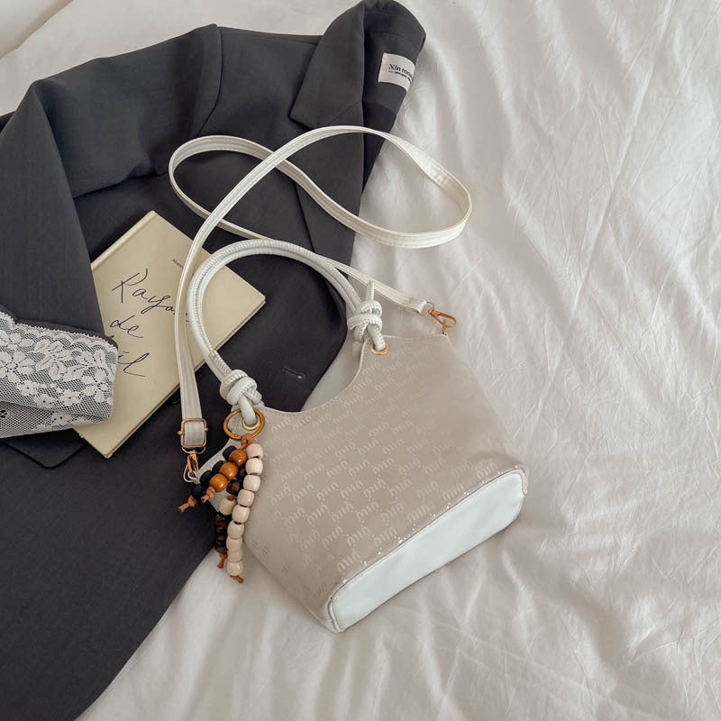 Ladies mini handbag with shimmering upper material and elegant accessories