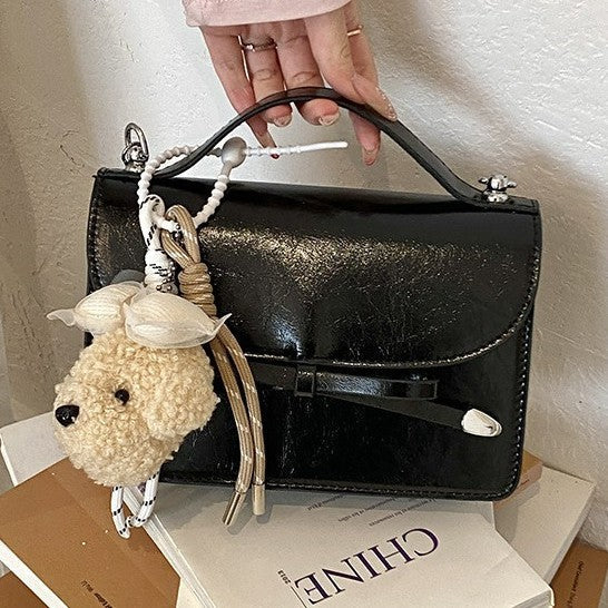 Ladies elegant mini handbag with cute pendant