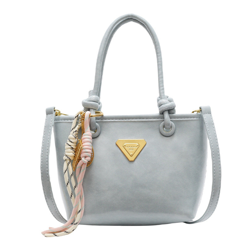 Mini handbag with elegant details and practical shoulder strap