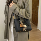 Ladies mini handbag in elegant design with charming pendant