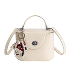 mini handbag in elegantly curved design with playful charm