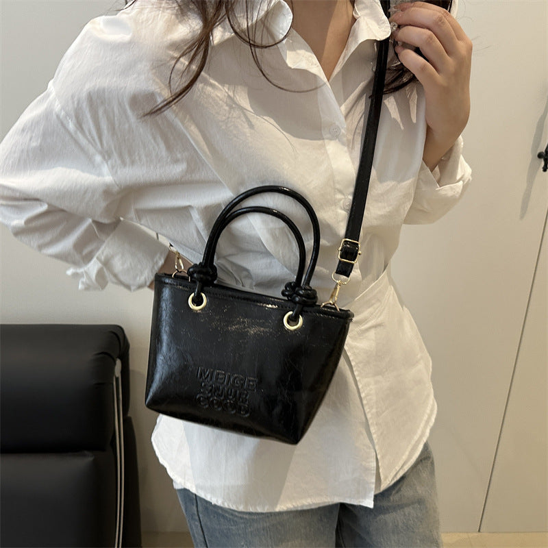 elegant mini handbag with textured design and detachable shoulder strap