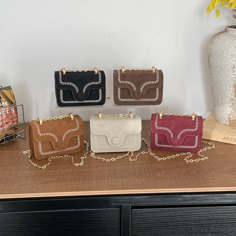 mini handbag with elegant quilted pattern and golden accents