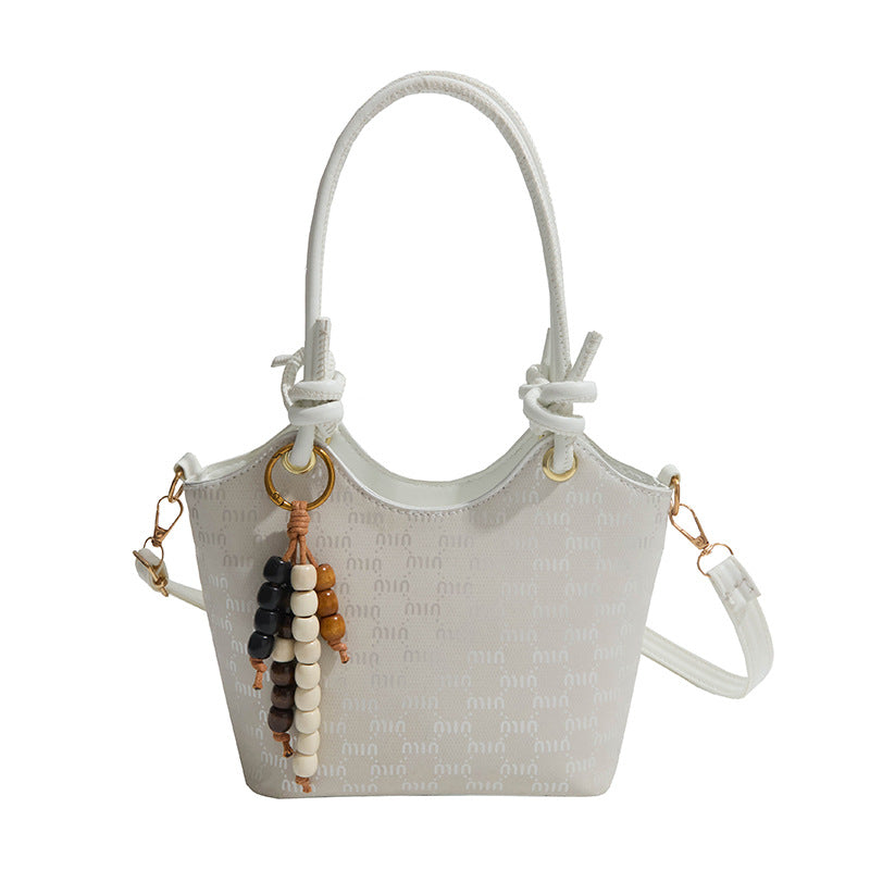 Ladies mini handbag with shimmering upper material and elegant accessories