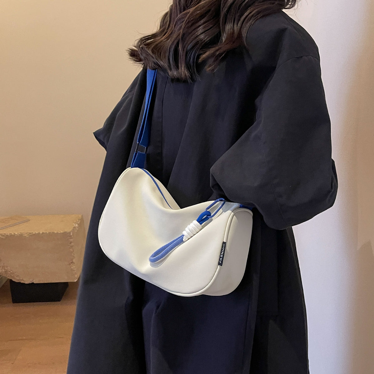 Fashionable shoulder bag with adjustable carrying strap