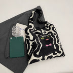 Shoulder bag with playful cat motif
