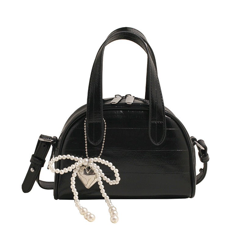 mini handbag with stylish crocodile look and detachable pendant