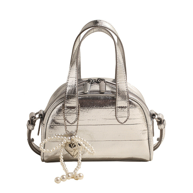 mini handbag with stylish crocodile look and detachable pendant