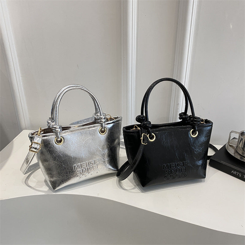 elegant mini handbag with textured design and detachable shoulder strap