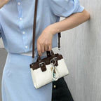 mini handbag with playful pendant and elegant design