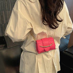 mini handbag with modern crocodile embossing and chic magnetic closure
