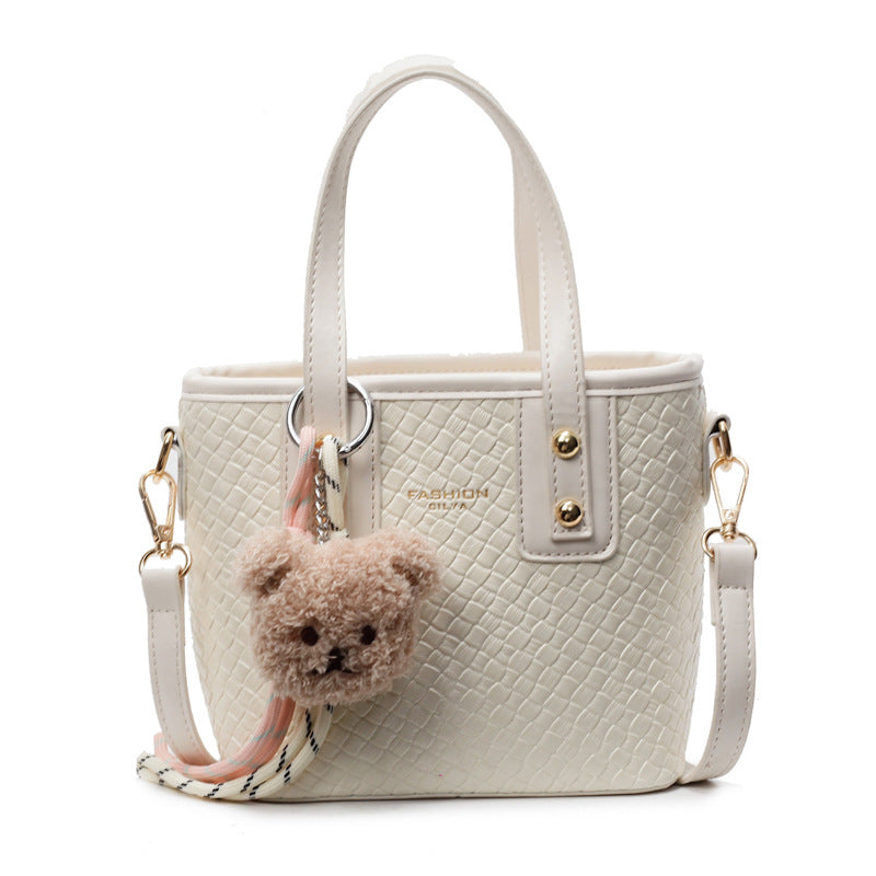 mini handbag with textured design and fluffy pendant