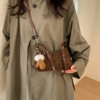 Women trendy mini handbag with playful animal pendant