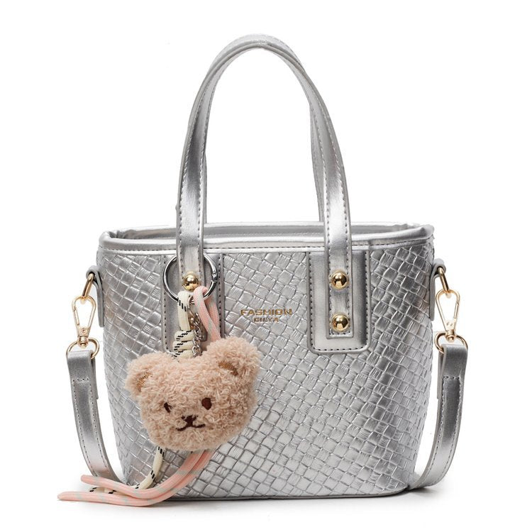mini handbag with textured design and fluffy pendant
